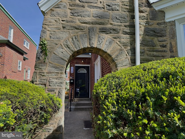 property entrance featuring stone siding