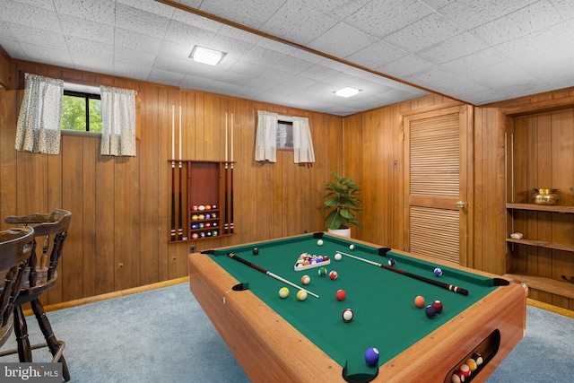 playroom with carpet floors, wood walls, and pool table