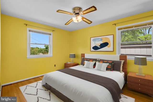 bedroom featuring baseboards and wood finished floors