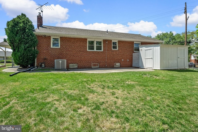 rear view of house with central AC, a storage shed, a chimney, a patio area, and an outdoor structure