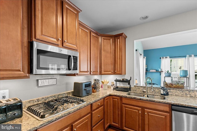 10 Warbler Ct, Stafford, VA 22554 - kitchen featuring a sink, light stone counters, stainless steel appliances, and brown cabinets