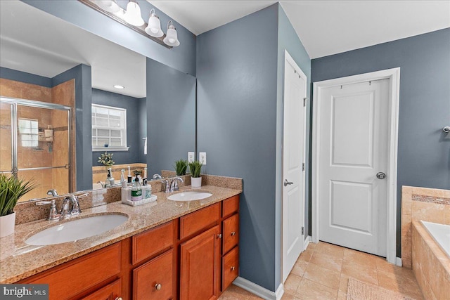 10 Warbler Ct, Stafford, VA 22554 - full bath with double vanity, tiled tub, a sink, and a stall shower