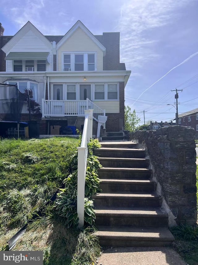 exterior space with brick siding and stairway