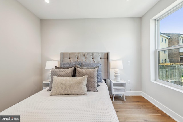 bedroom with baseboards, recessed lighting, and wood finished floors