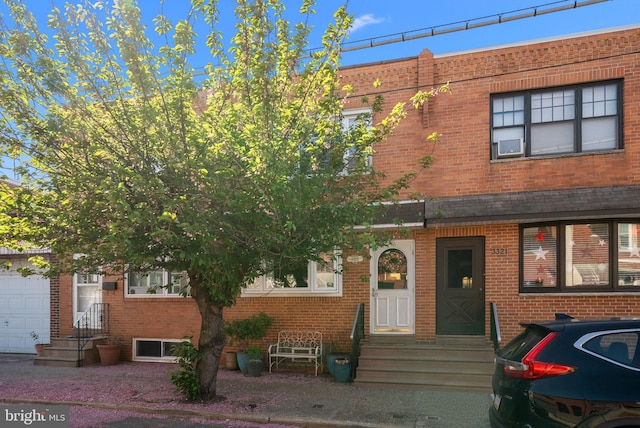 townhome / multi-family property with brick siding and entry steps