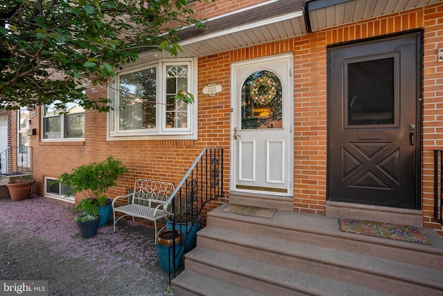 property entrance featuring brick siding