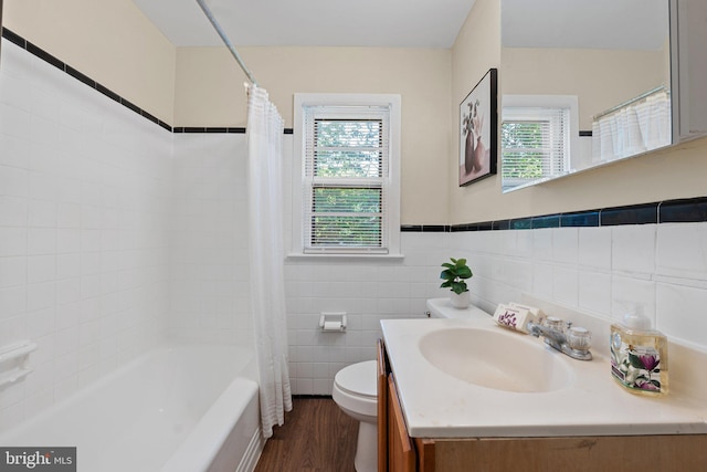 full bath featuring a healthy amount of sunlight, vanity, toilet, and wood finished floors
