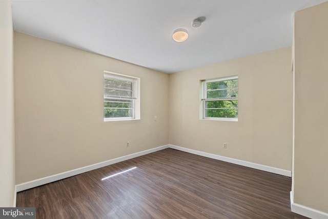 spare room with baseboards and a healthy amount of sunlight