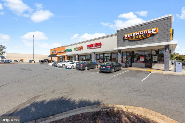 view of building exterior with uncovered parking