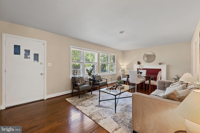 living room featuring baseboards and hardwood / wood-style flooring