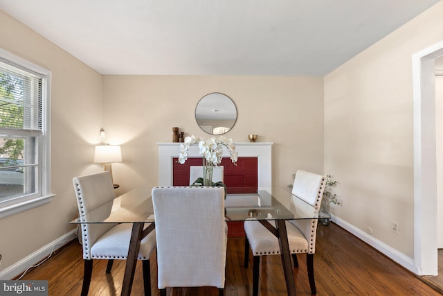 dining area featuring baseboards and wood finished floors