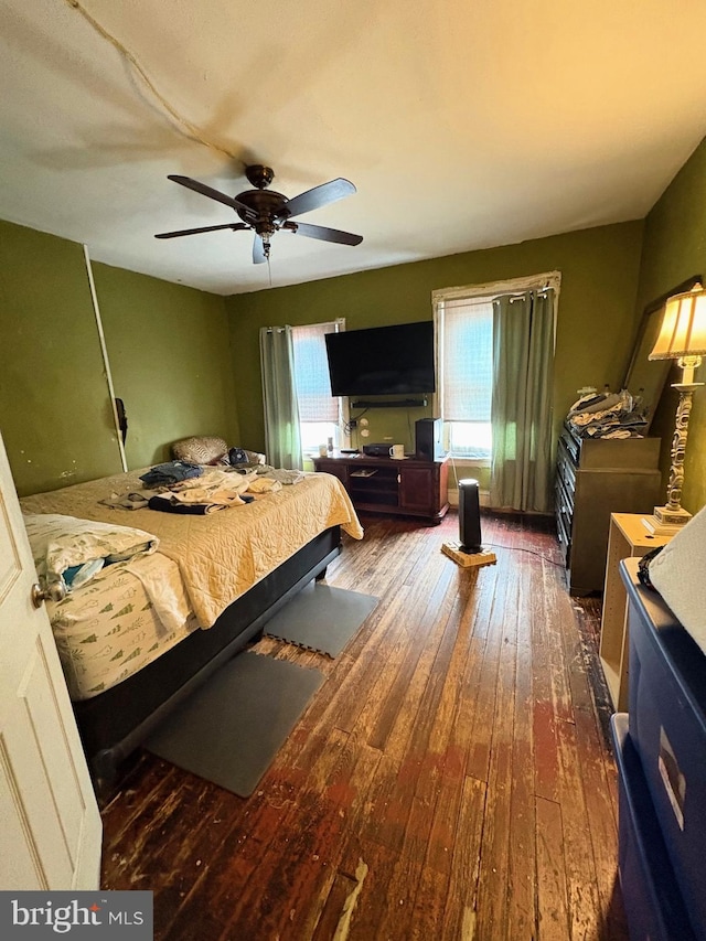 bedroom with a ceiling fan and hardwood / wood-style flooring