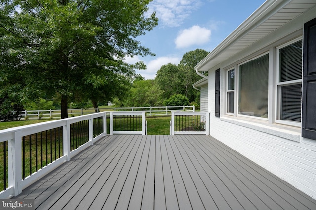 wooden deck featuring a fenced backyard and a yard