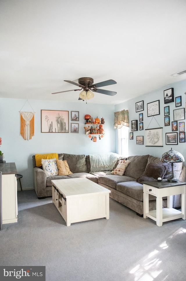 carpeted living area with a ceiling fan and visible vents