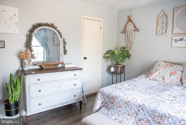 bedroom with dark wood-style flooring