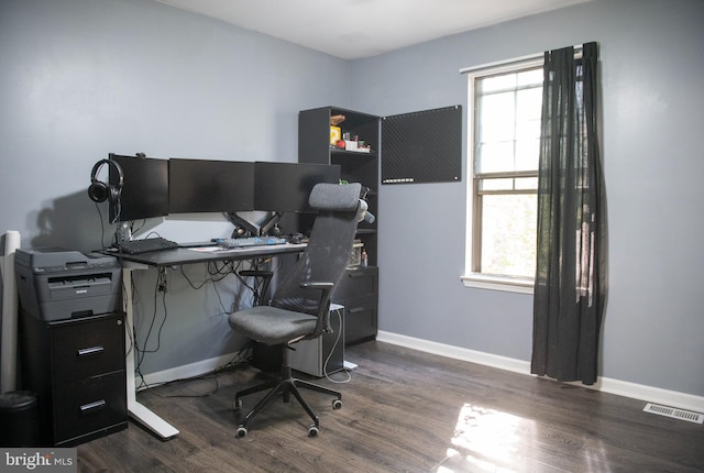 office area with visible vents, dark wood-style flooring, and a healthy amount of sunlight