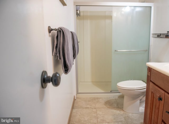 full bathroom featuring vanity, toilet, baseboards, tile patterned floors, and a stall shower