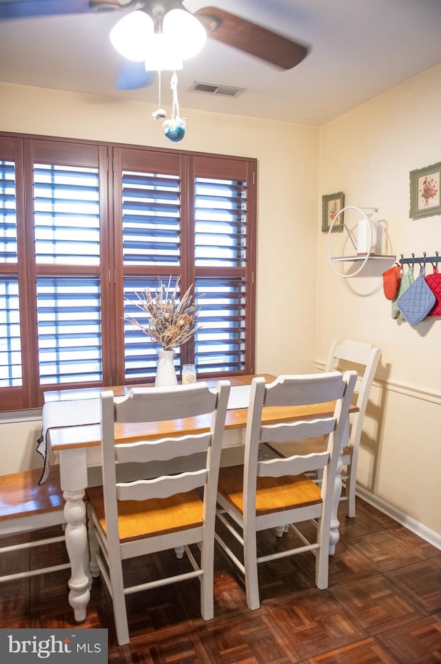 dining space featuring visible vents, baseboards, and ceiling fan