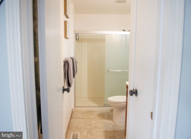 full bathroom featuring toilet, tile patterned floors, baseboards, visible vents, and a stall shower
