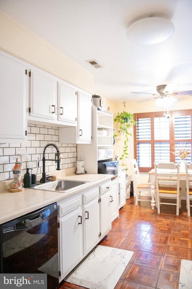 kitchen with visible vents, ceiling fan, white cabinets, a sink, and dishwasher