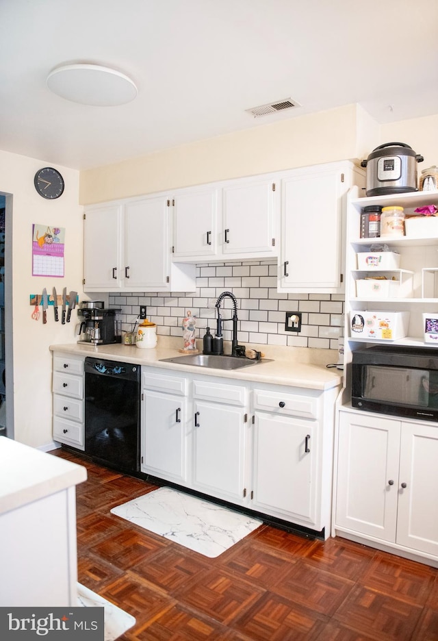 kitchen featuring a sink, visible vents, white cabinets, and dishwasher