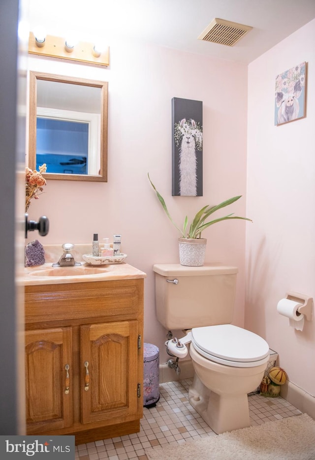 bathroom with visible vents, tile patterned flooring, toilet, and vanity