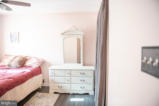 bedroom with a ceiling fan and dark wood-style flooring