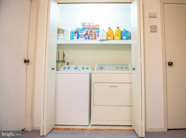 clothes washing area with laundry area and washer and clothes dryer