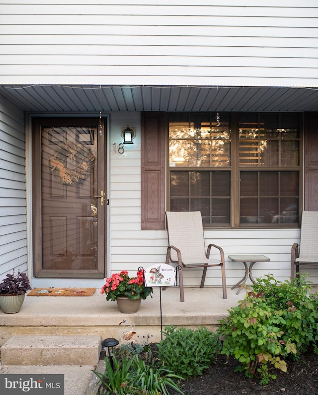 view of exterior entry featuring a porch