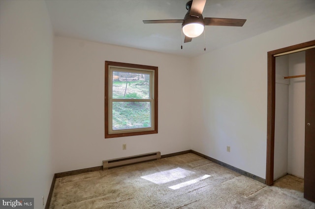 unfurnished bedroom featuring light colored carpet, baseboards, ceiling fan, and a baseboard heating unit