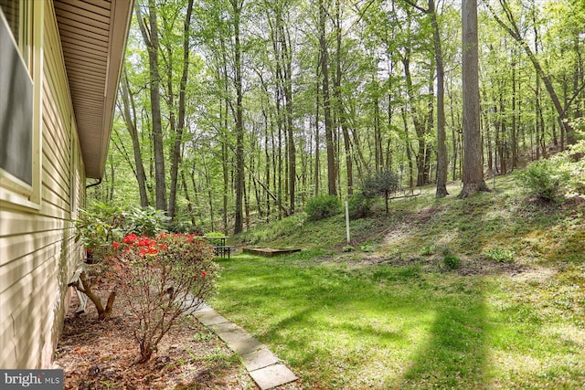 view of yard with a view of trees
