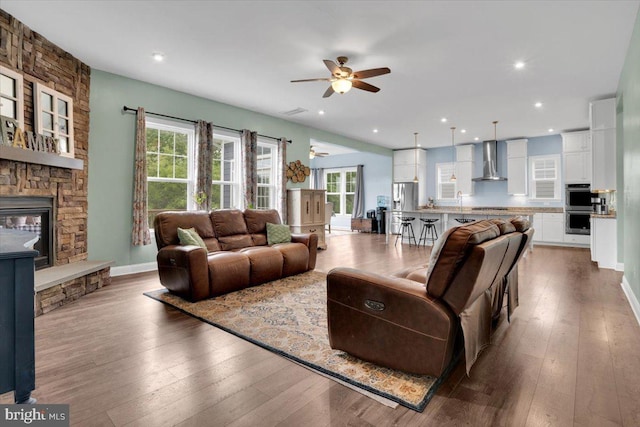 40918 White Clover Ln, Aldie, VA 20105 - living area featuring a ceiling fan, healthy amount of natural light, a stone fireplace, hardwood / wood-style floors, and recessed lighting
