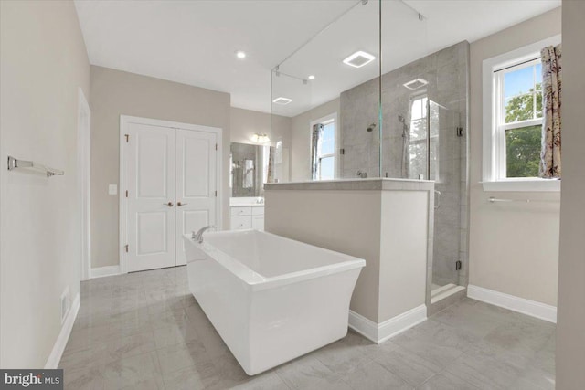 40918 White Clover Ln, Aldie, VA 20105 - bathroom with a stall shower, baseboards, a freestanding tub, vanity, and recessed lighting