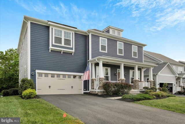 40918 White Clover Ln, Aldie, VA 20105 - view of front of home featuring covered porch, an attached garage, asphalt driveway, and a front lawn