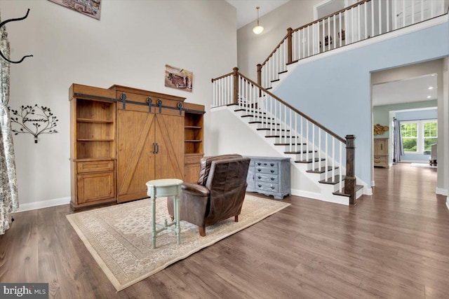 40918 White Clover Ln, Aldie, VA 20105 - living area featuring a towering ceiling, stairway, wood finished floors, and baseboards