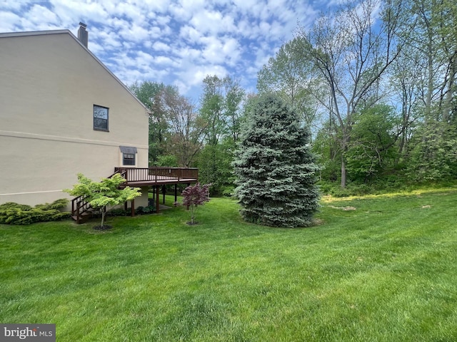 view of yard featuring a wooden deck
