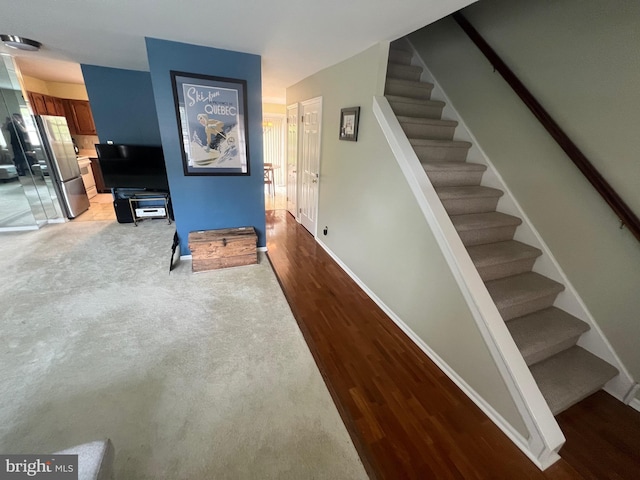 stairs with baseboards and wood finished floors