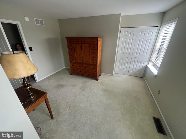 living area with carpet floors, baseboards, and visible vents
