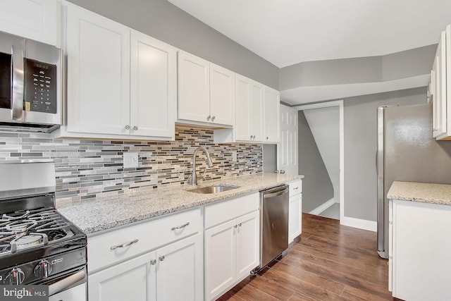 324 Woodbourne Ave, Baltimore, MD 21212 - kitchen featuring stainless steel appliances, white cabinets, wood finished floors, tasteful backsplash, and light stone counters