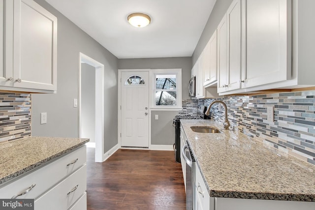 324 Woodbourne Ave, Baltimore, MD 21212 - kitchen featuring stainless steel appliances, light stone countertops, white cabinetry, and tasteful backsplash