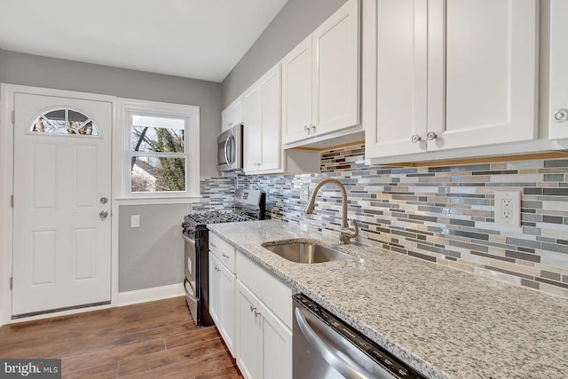 324 Woodbourne Ave, Baltimore, MD 21212 - kitchen with appliances with stainless steel finishes, tasteful backsplash, white cabinetry, and light stone counters