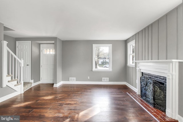 324 Woodbourne Ave, Baltimore, MD 21212 - unfurnished living room with dark wood finished floors, stairs, and a fireplace