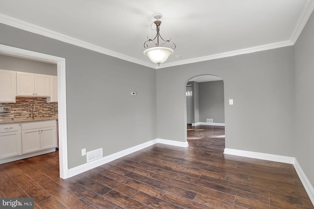 324 Woodbourne Ave, Baltimore, MD 21212 - empty room with arched walkways, crown molding, and dark wood-style flooring