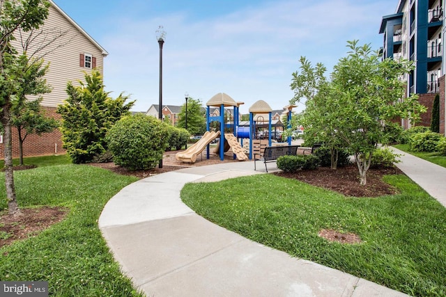 view of home's community with a yard and a playground