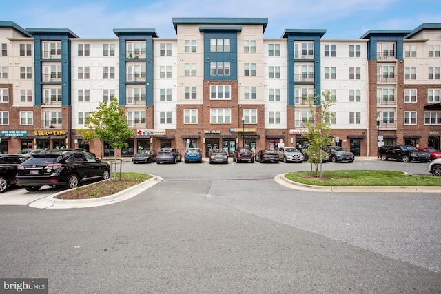 view of building exterior featuring uncovered parking
