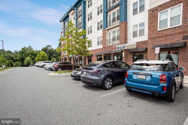 view of building exterior with uncovered parking