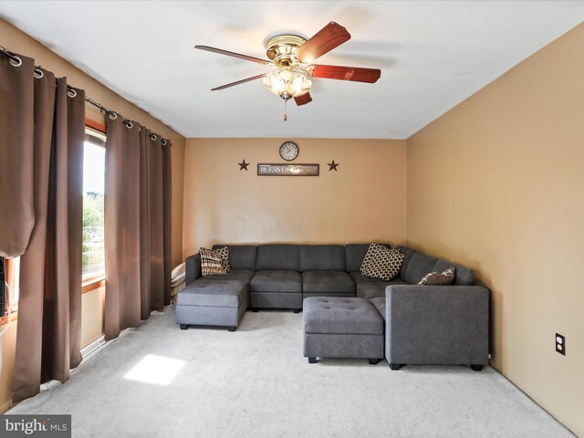 living room featuring a ceiling fan and light colored carpet