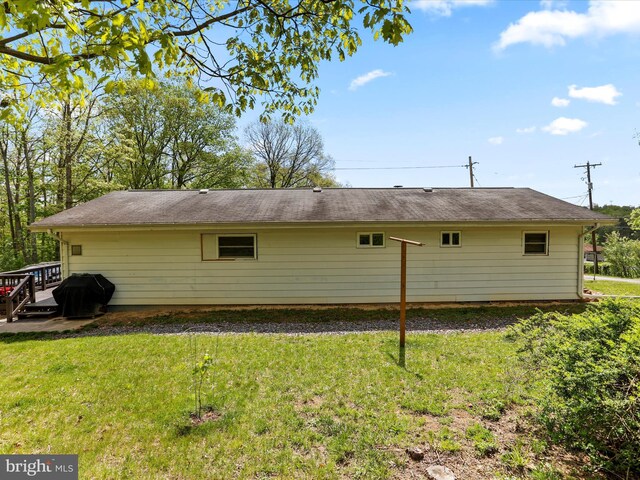 back of house with a lawn