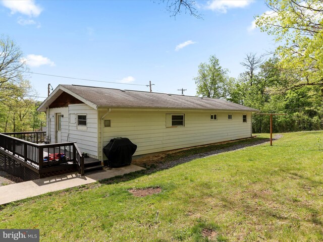 back of house featuring a yard and a deck