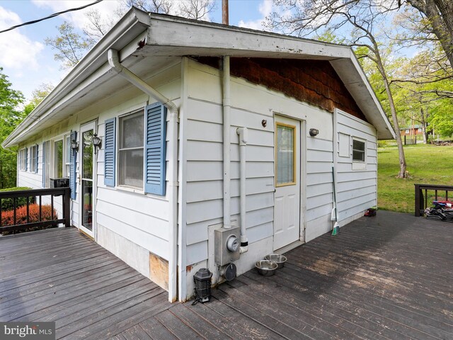 view of side of property featuring a wooden deck